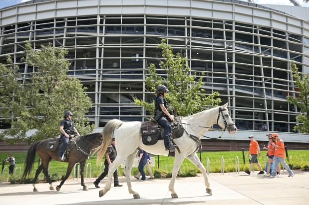 Denver Police officers patrol outside the stadium with horses at Empower Field at Mile High in Denver on Sunday, Sept. 7, 2025. (Photo by Hyoung Chang/The Denver Post)
