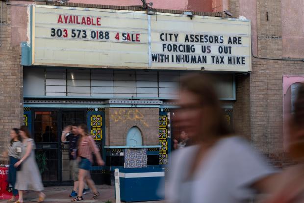 Pedestrians walk past the Aztlan Theatre on Friday, June 7, 2024, in Denver. (Rebecca Slezak/Special to The Denver Post)